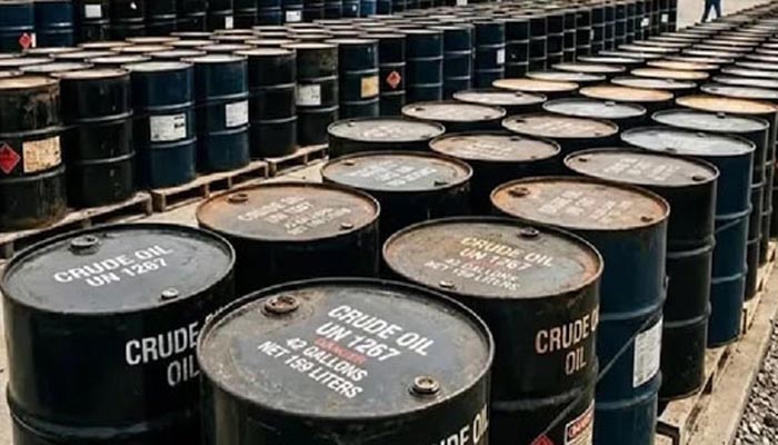 Oil barrels at a refinery representing the surge in global crude oil prices amid US-Iran tensions and supply disruptions.