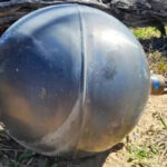 Mysterious silver-colored metal balls found on an Australian beach, later identified as rocket fuel tanks