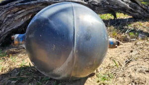 Mysterious silver-colored metal balls found on an Australian beach, later identified as rocket fuel tanks