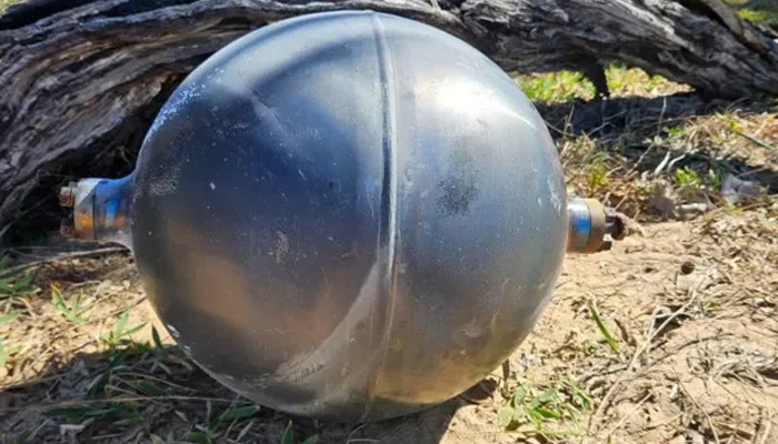 Mysterious silver-colored metal balls found on an Australian beach, later identified as rocket fuel tanks