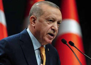 Turkish President Recep Tayyip Erdogan delivering a speech at the NATO Summit, emphasizing unity and cooperation among allied nations.